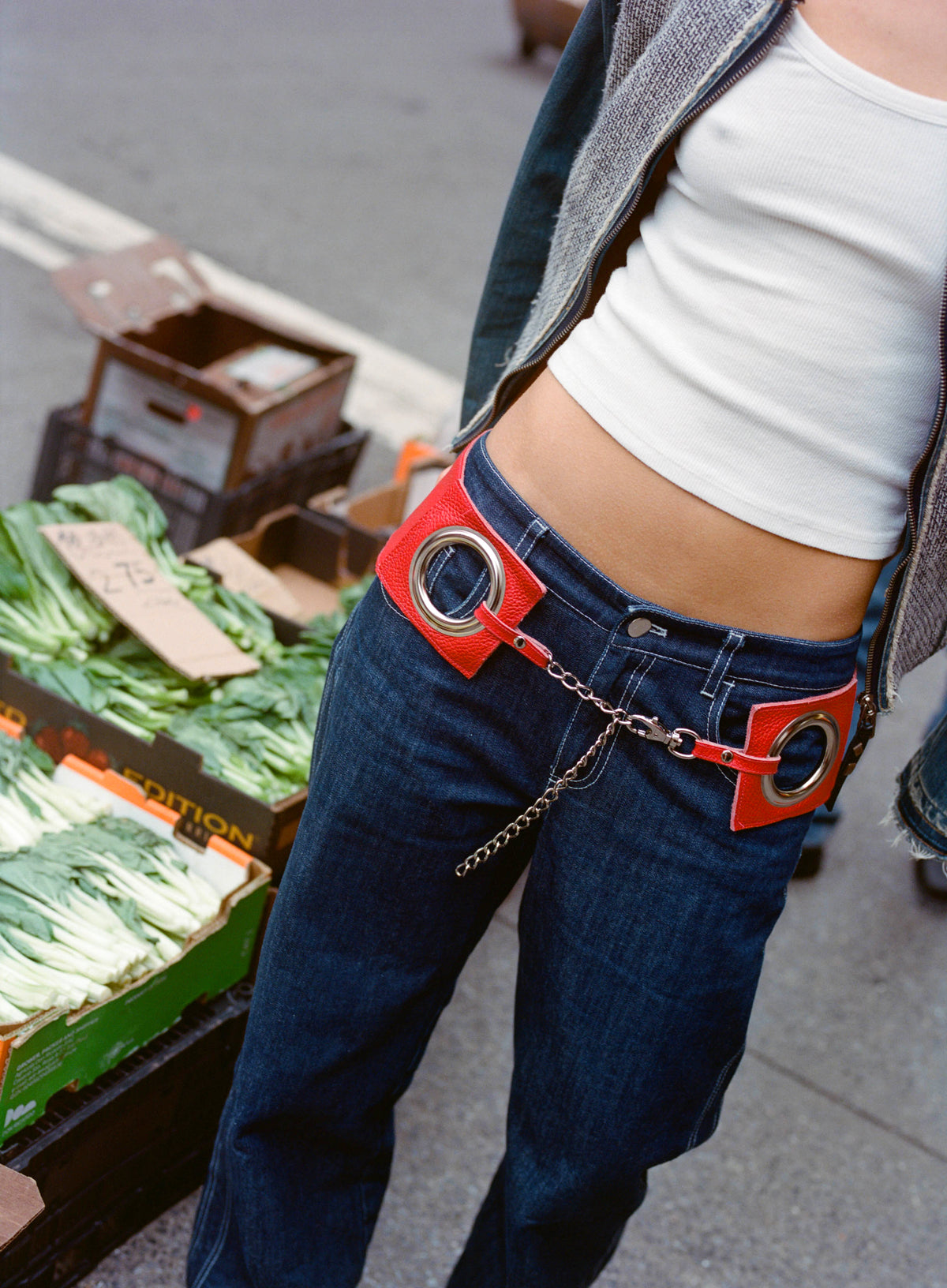 Close-up of the Bella Belt in Ruby's silver rings and chain, worn on dark jeans